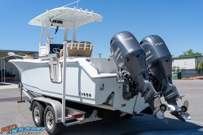 Slide: The Image of 2017 Sea Hunt Gamefish 25 boat with dual Yamaha 150 engines on a trailer. - 8