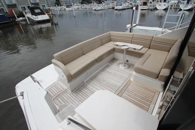 Slide: The Image of Luxurious seating area on 2016 Sea Ray 510 Sundancer yacht, docked at marina. - 12
