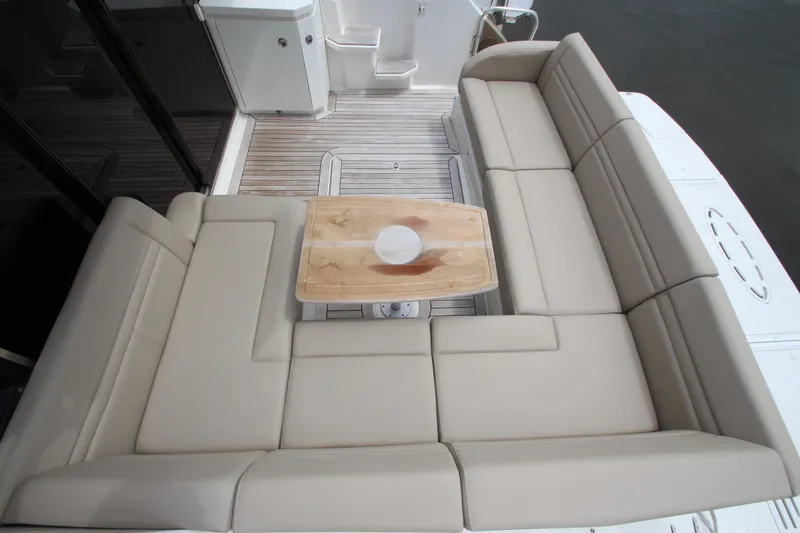 Slide: The Image of Luxurious seating area on 2016 Sea Ray 510 Sundancer yacht with wooden table. - 16