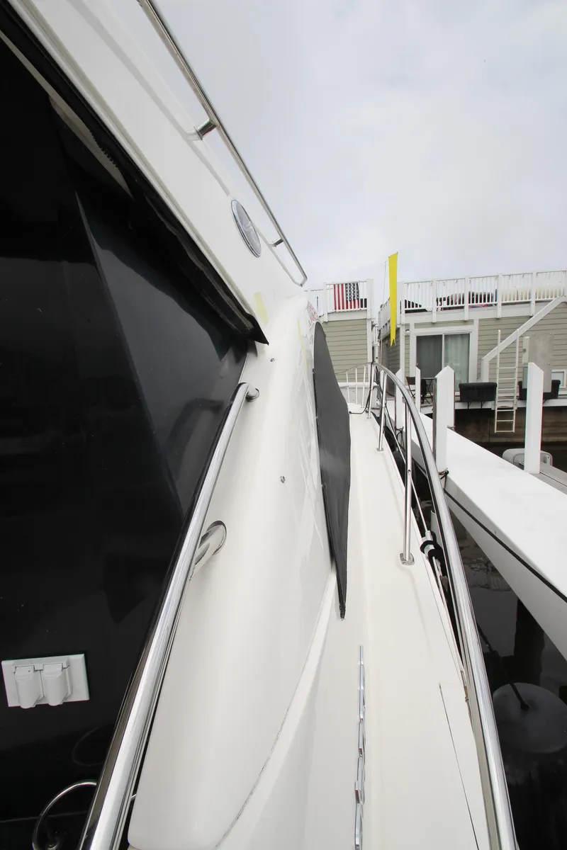 Slide: The Image of 2016 Sea Ray 510 Sundancer yacht docked, showcasing sleek design and modern features. - 21