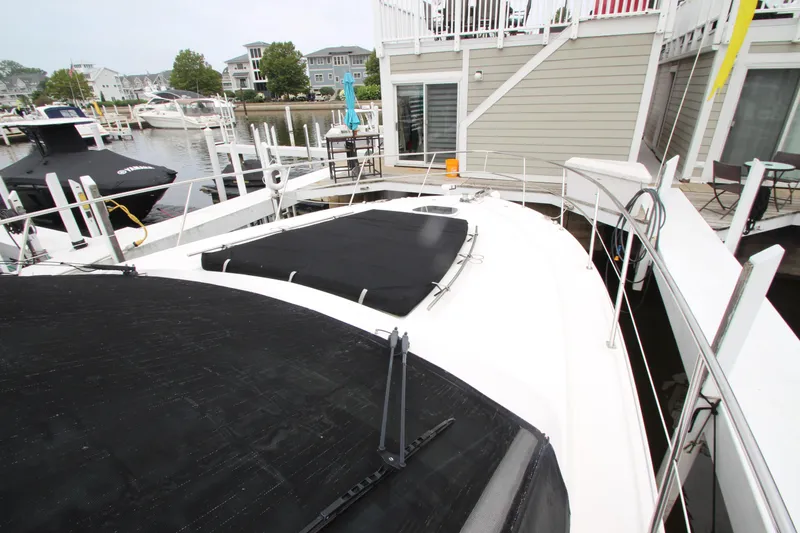 Slide: The Image of 2016 Sea Ray 510 Sundancer docked at marina, featuring sleek design and spacious deck. - 22