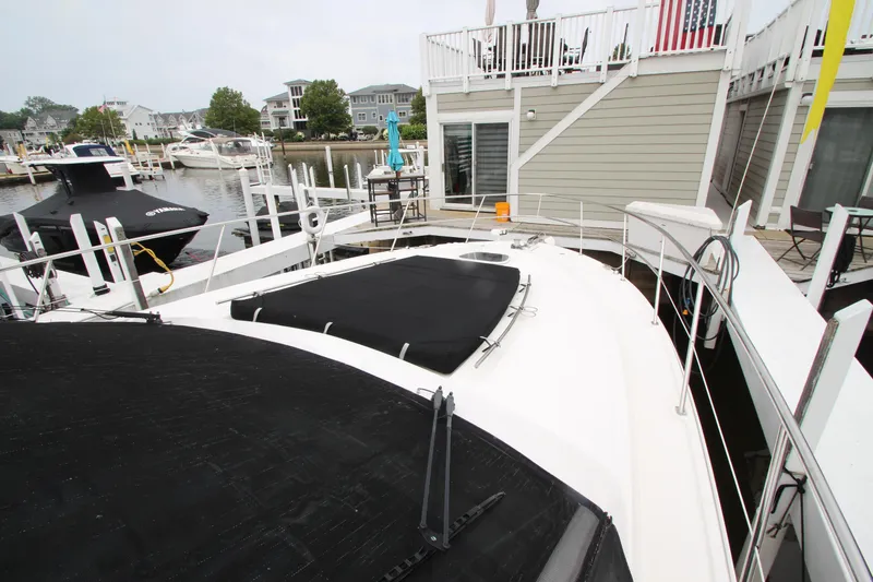 Slide: The Image of 2016 Sea Ray 510 Sundancer docked near waterfront homes. - 23