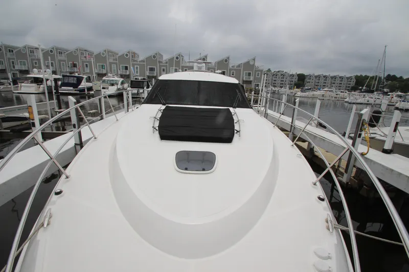 Slide: The Image of 2016 Sea Ray 510 Sundancer yacht docked at marina with overcast sky. - 25