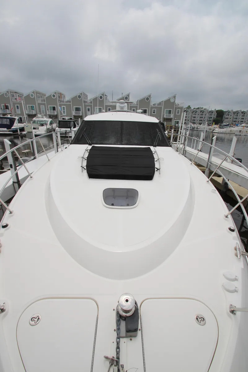 Slide: The Image of 2016 Sea Ray 510 Sundancer yacht docked at marina, overcast sky. - 26