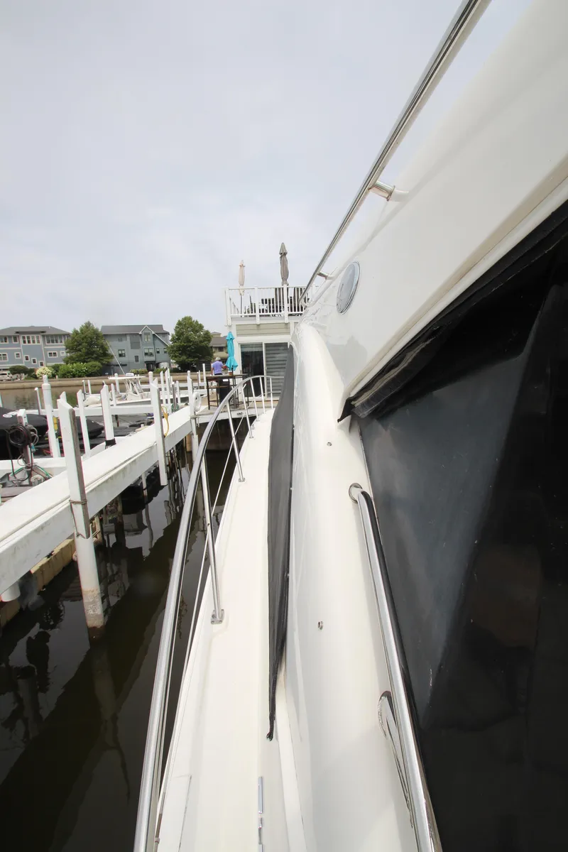 Slide: The Image of 2016 Sea Ray 510 Sundancer yacht docked at marina, side view. - 28