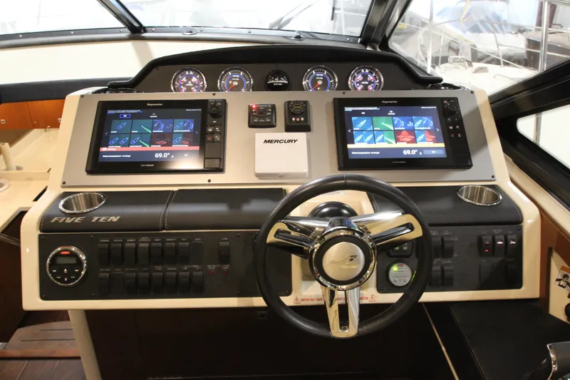 Slide: The Image of 2016 Sea Ray 510 Sundancer helm with dual displays and modern controls. - 32
