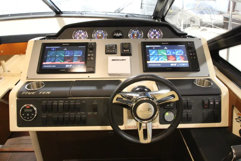 Slide: The Image of Helm of 2016 Sea Ray 510 Sundancer with dual displays and controls. - 33