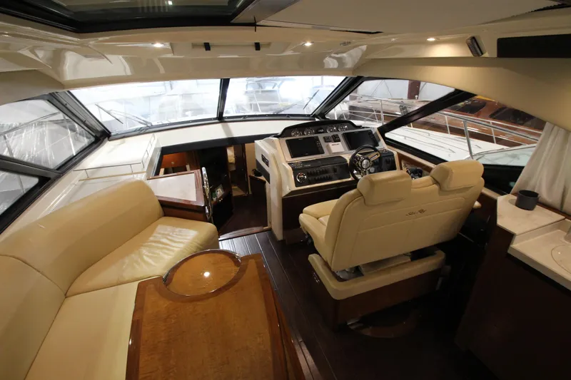 Slide: The Image of Luxurious interior of 2016 Sea Ray 510 Sundancer yacht with leather seating and modern helm. - 34