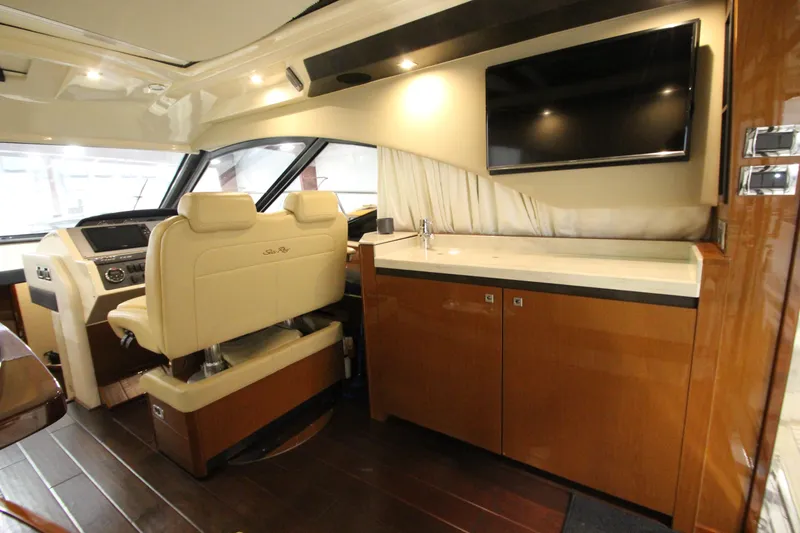 Slide: The Image of 2016 Sea Ray 510 Sundancer interior with helm, seating, and entertainment area. - 37
