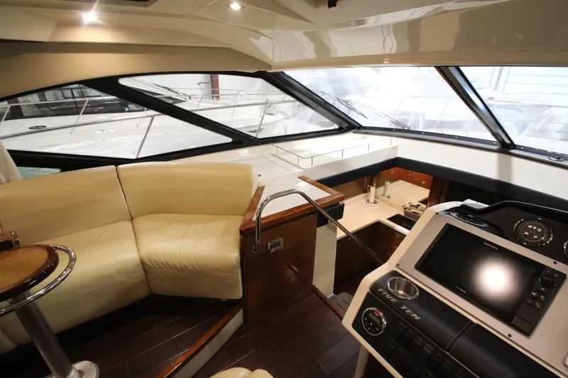 Slide: The Image of Interior of 2016 Sea Ray 510 Sundancer yacht with helm and seating area. - 40