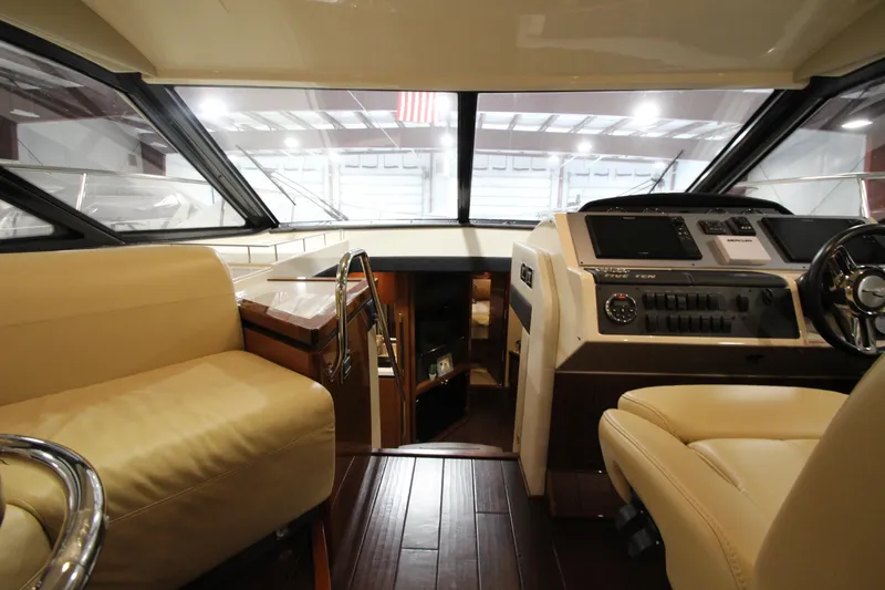 Slide: The Image of Interior of 2016 Sea Ray 510 Sundancer yacht with luxurious seating and modern dashboard. - 45