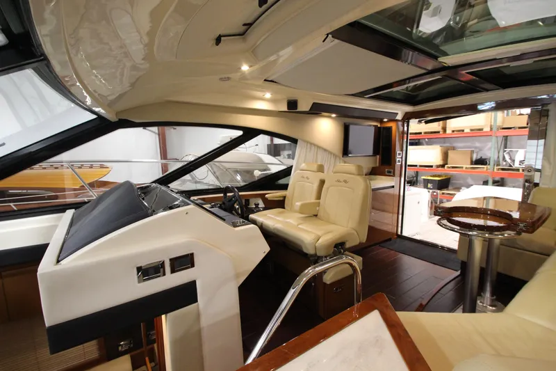 Slide: The Image of Interior of 2016 Sea Ray 510 Sundancer yacht with luxurious seating and modern helm. - 49
