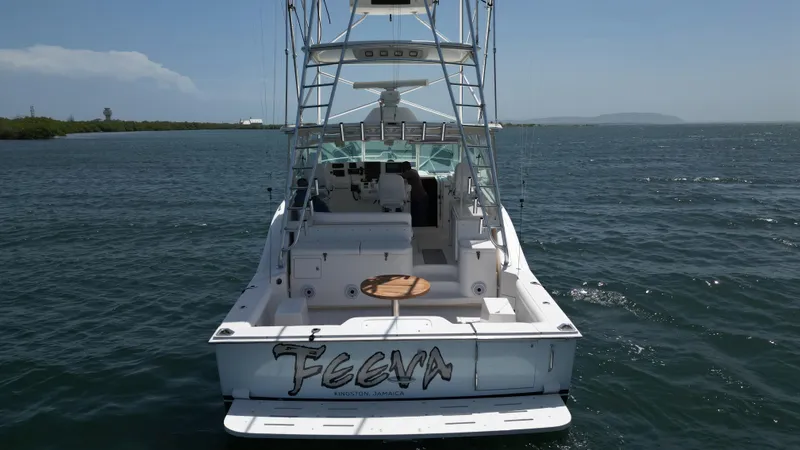 Slide: The Image of 2007 Cabo 40 Hardtop Express boat on water, rear view, clear sky. - 10