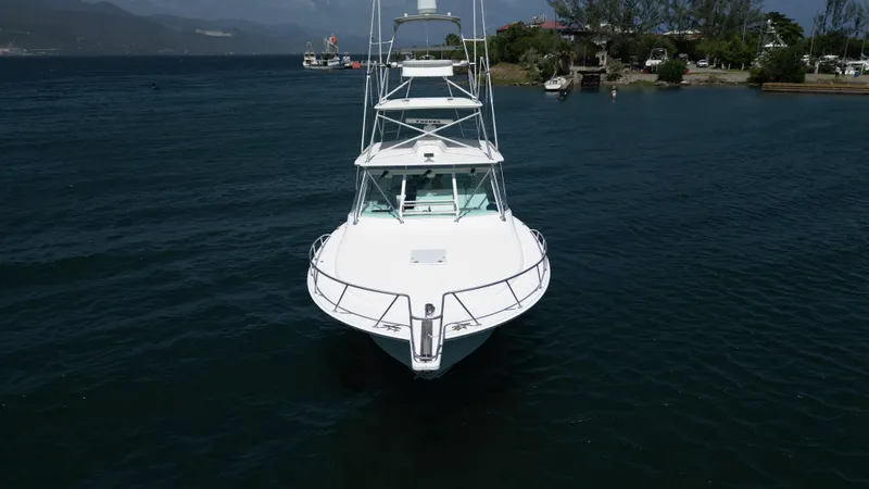 Slide: The Image of 2007 Cabo 40 Hardtop Express yacht on calm water, front view. - 14