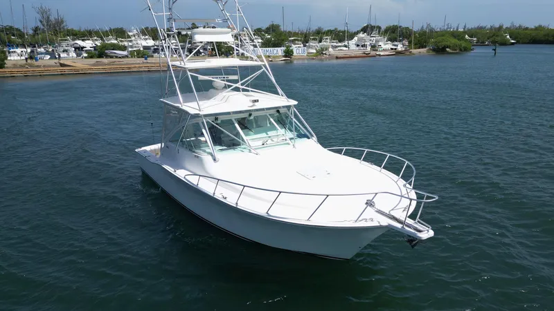 Slide: The Image of 2007 Cabo 40 Hardtop Express yacht on calm water, featuring sleek design and spacious deck. - 15
