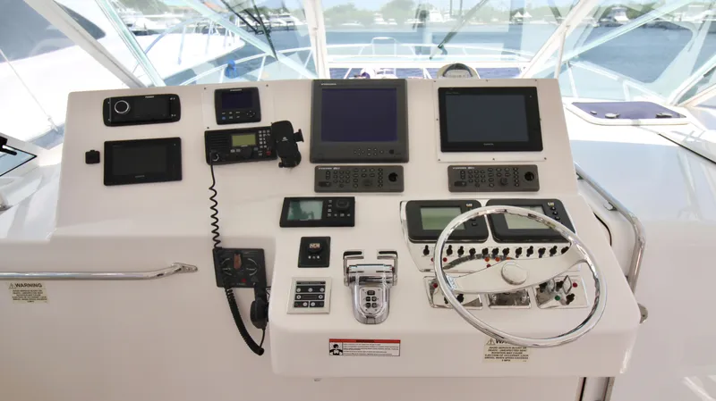 Slide: The Image of Control panel of a 2007 Cabo 40 Hardtop Express boat with navigation equipment. - 19