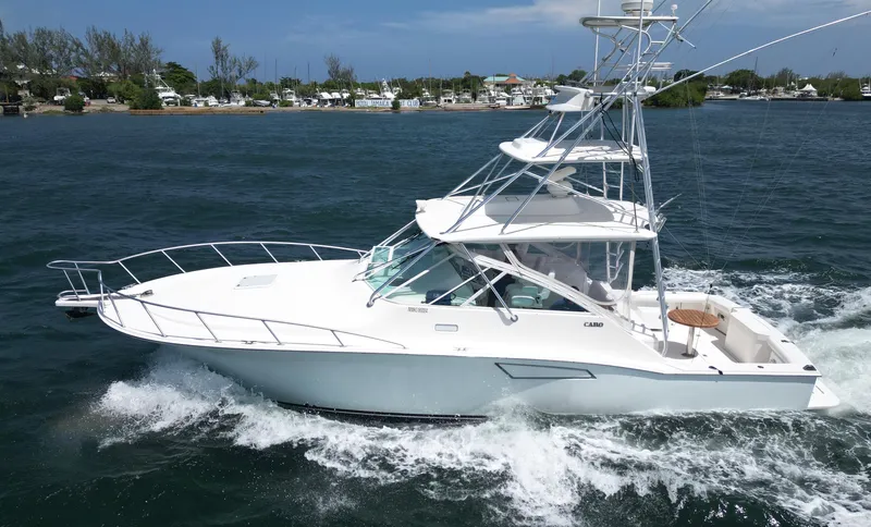 Slide: The Image of 2007 Cabo 40 Hardtop Express yacht cruising on a sunny day. - 2