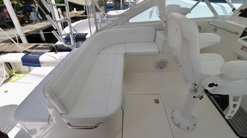Slide: The Image of 2007 Cabo 40 Hardtop Express boat interior with white seating and helm station. - 21