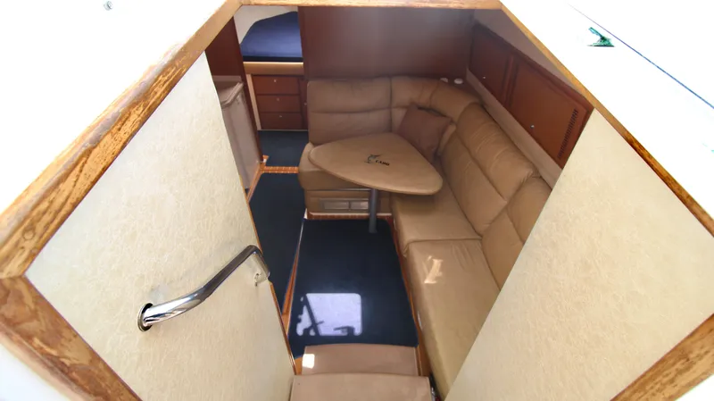 Slide: The Image of Interior of 2007 Cabo 40 Hardtop Express with beige seating and wooden accents. - 23