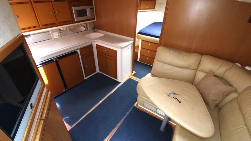 Slide: The Image of Interior of 2007 Cabo 40 Hardtop Express yacht with kitchen and seating area. - 26