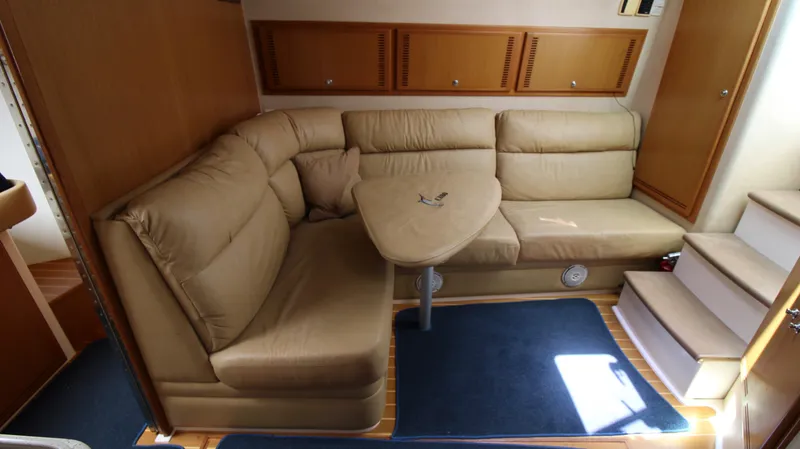 Slide: The Image of Luxurious interior of 2007 Cabo 40 Hardtop Express with beige seating and wooden accents. - 27
