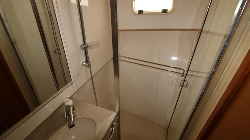 Slide: The Image of 2007 Cabo 40 Hardtop Express bathroom with shower, sink, and window. - 31