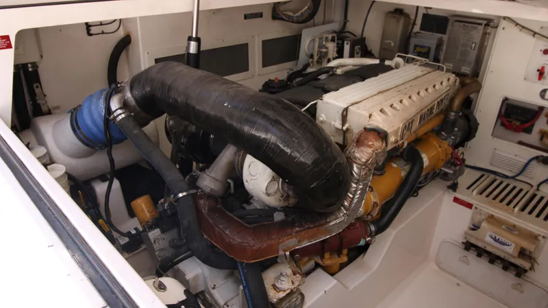 Slide: The Image of Engine room of a 2007 Cabo 40 Hardtop Express boat, showcasing detailed machinery. - 32