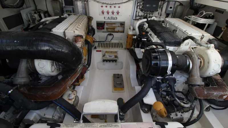 Slide: The Image of Engine room of a 2007 Cabo 40 Hardtop Express, showcasing dual engines and mechanical components. - 33