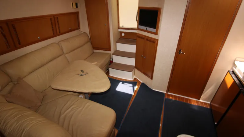Slide: The Image of Interior of 2007 Cabo 40 Hardtop Express with beige seating and compact design. - 38