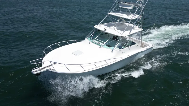 Slide: The Image of 2007 Cabo 40 Hardtop Express yacht cruising on open water. - 5