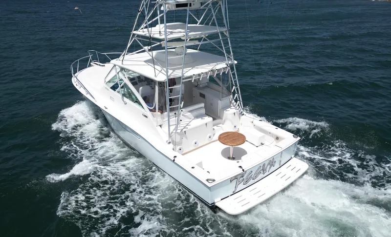 Slide: The Image of 2007 Cabo 40 Hardtop Express yacht cruising on open water. - 6