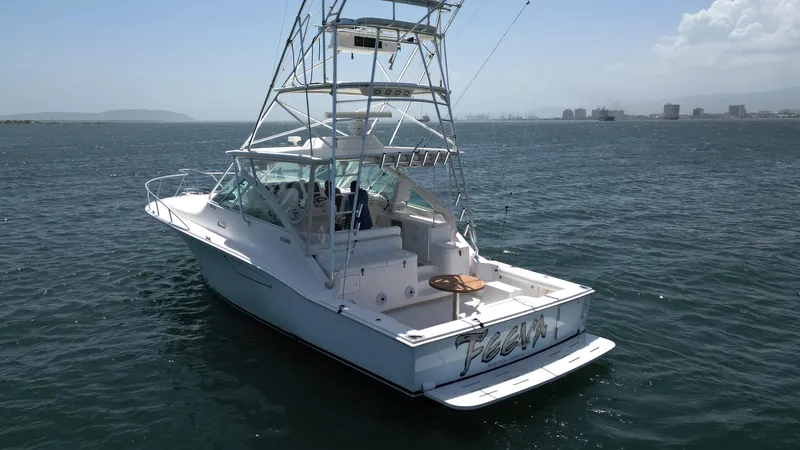 Slide: The Image of 2007 Cabo 40 Hardtop Express boat on open water, featuring a sleek design and fishing tower. - 9