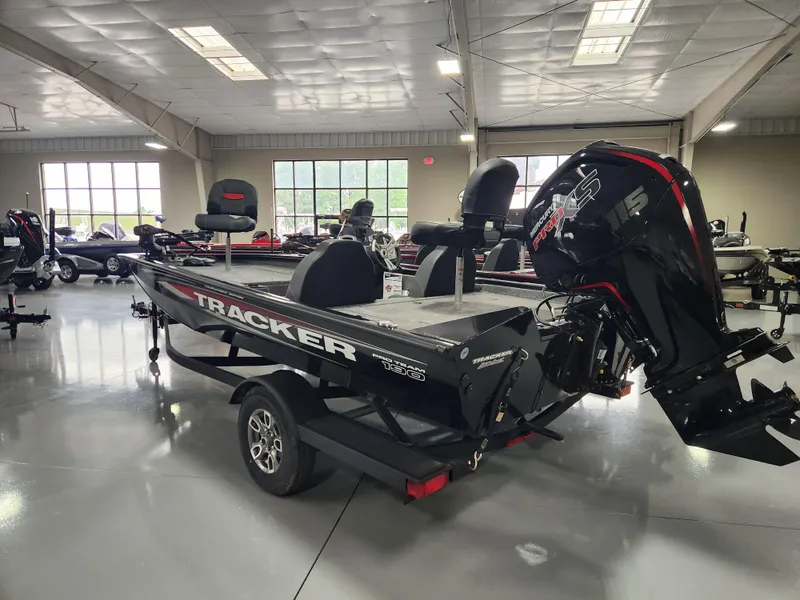 Slide: The Image of 2025 Tracker Pro Team 190 boat in showroom, featuring sleek design and powerful engine. - 2