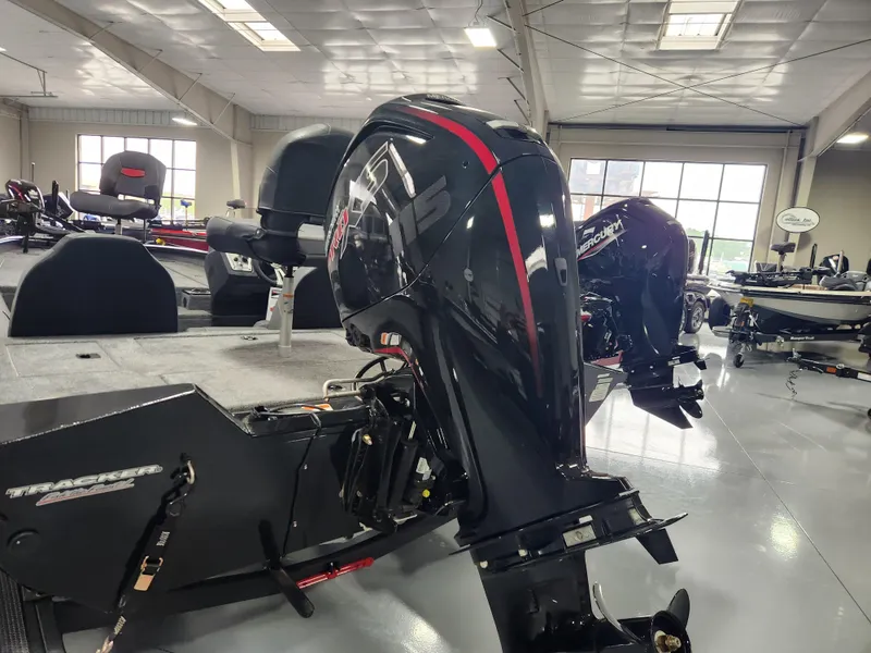 Slide: The Image of 2025 Tracker Pro Team 190 boat with powerful outboard motor in showroom. - 3