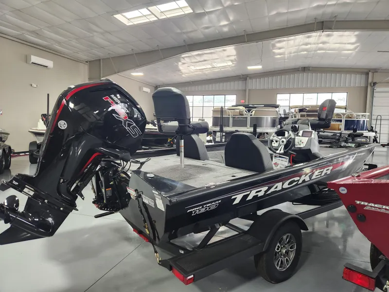 Slide: The Image of 2025 Tracker Pro Team 190 boat in showroom, featuring sleek design and powerful outboard motor. - 4