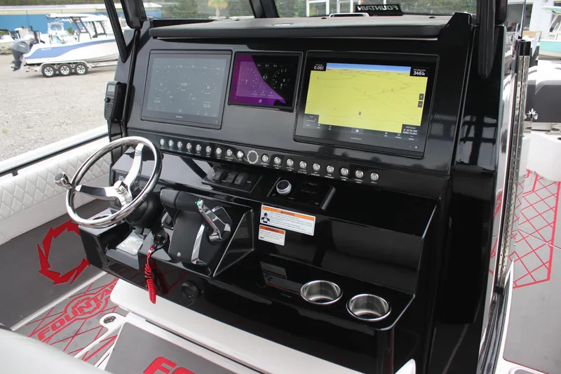 Slide: The Image of 2024 Fountain 32 NX boat dashboard with advanced navigation and control systems. - 10