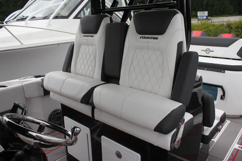 Slide: The Image of 2024 Fountain 32 NX boat interior with luxurious seating and steering wheel. - 11