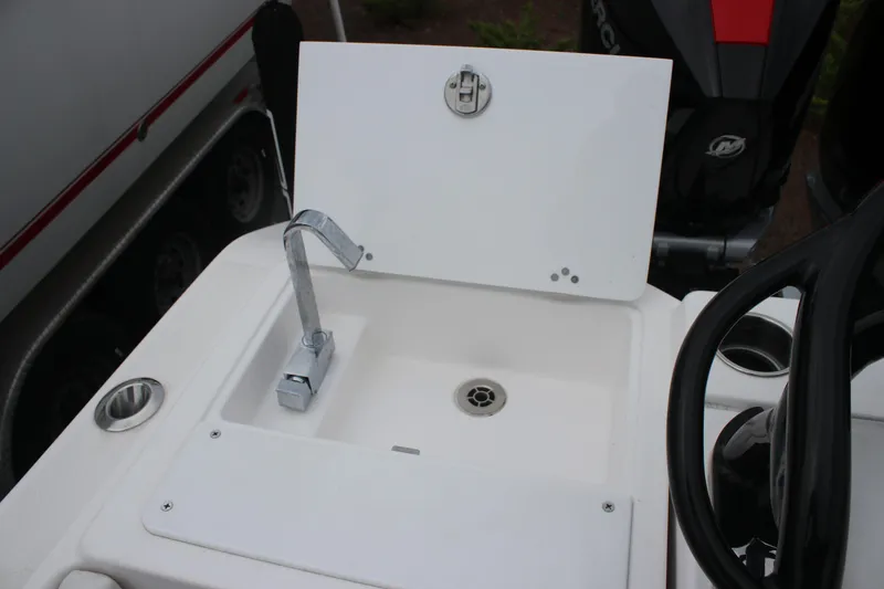 Slide: The Image of 2024 Fountain 32 NX boat sink with faucet and storage compartment. - 14