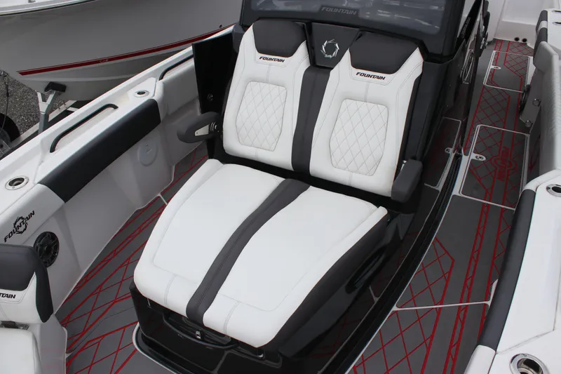 Slide: The Image of 2024 Fountain 32 NX boat interior with luxurious white and black seating. - 16