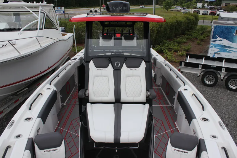 Slide: The Image of 2024 Fountain 32 NX boat interior with white seating and Garmin navigation system. - 17