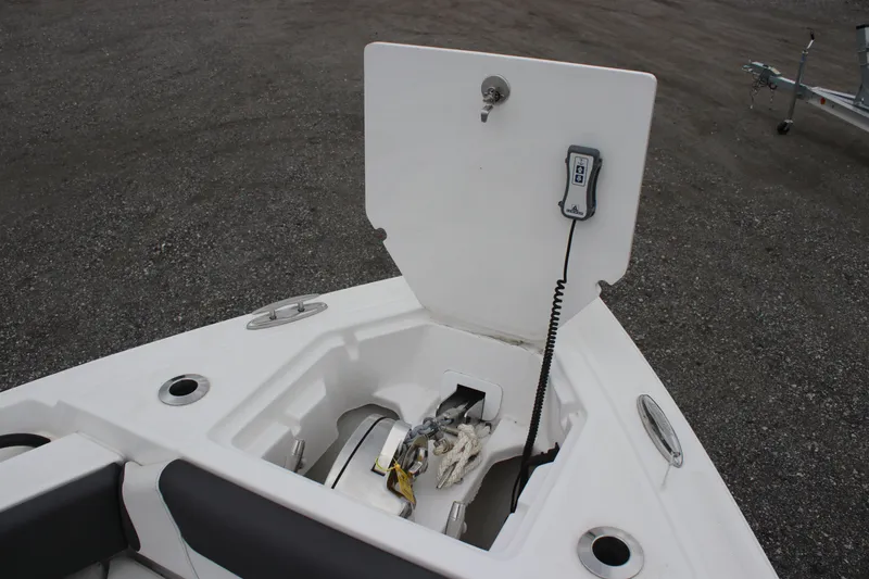 Slide: The Image of 2024 Fountain 32 NX boat anchor compartment with open hatch and control panel. - 19