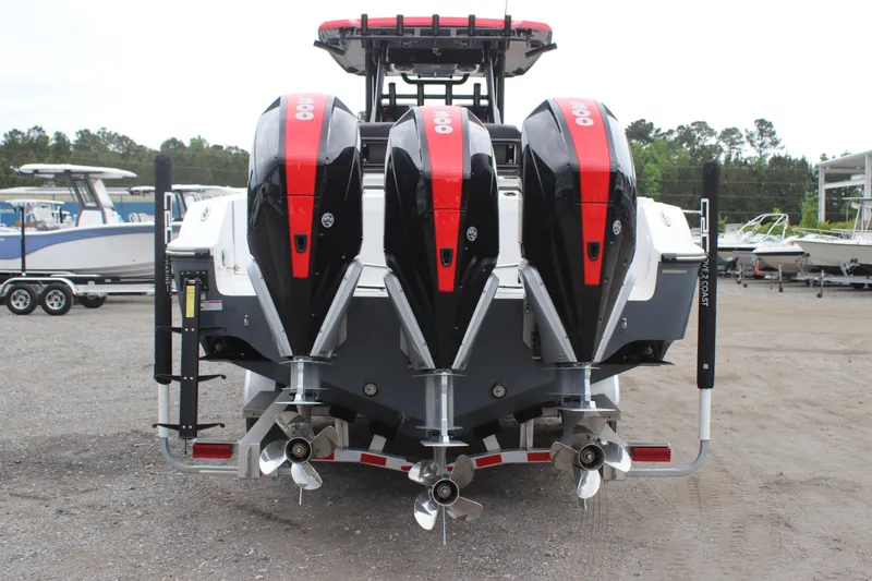 Slide: The Image of 2024 Fountain 32 NX boat with triple outboard engines, rear view. - 2