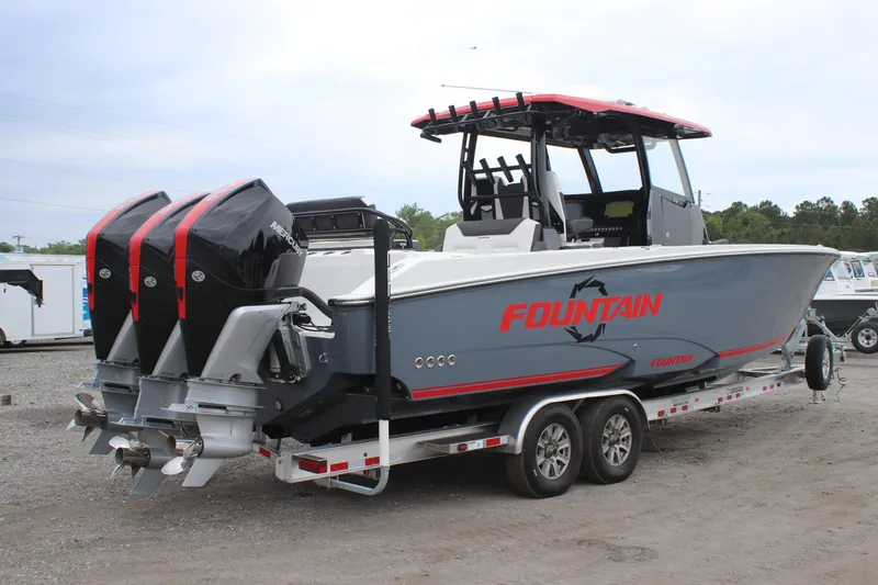 Slide: The Image of 2024 Fountain 32 NX boat with triple engines on a trailer. - 4