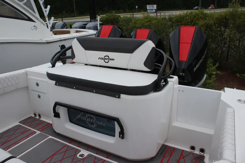 Slide: The Image of 2024 Fountain 32 NX boat with triple Mercury engines and cushioned seating. - 6