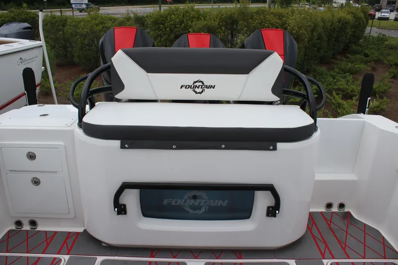 Slide: The Image of 2024 Fountain 32 NX boat seating area with logo, featuring modern design and storage compartments. - 8
