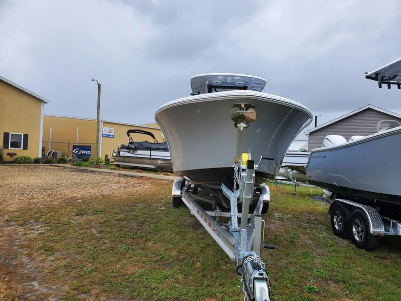 Slide: The Image of 2025 Sportsman Heritage 261 Center Console boat on trailer, parked outdoors. - 1