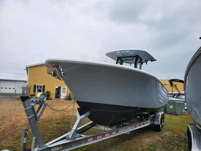Slide: The Image of 2025 Sportsman Heritage 261 Center Console boat on trailer, outdoor display. - 2