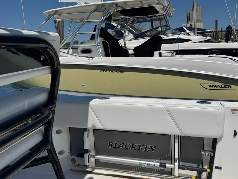 Slide: The Image of 2020 Blackfin 212 CC boat docked, featuring sleek design and modern amenities. - 10