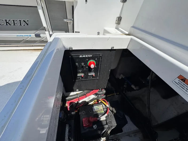 Slide: The Image of 2020 Blackfin 212 CC boat battery compartment with control panel and wiring. - 12