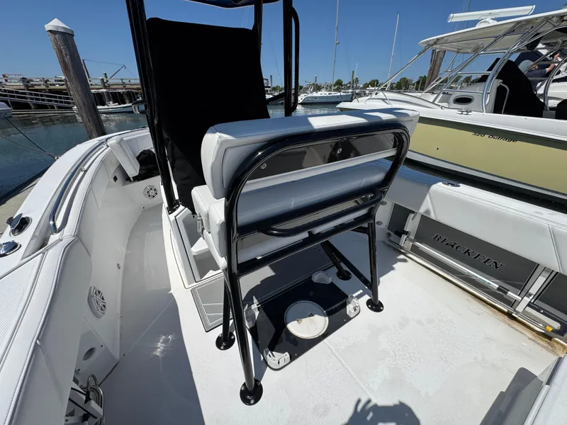 Slide: The Image of 2020 Blackfin 212 CC boat interior with seating and console, docked at marina. - 13